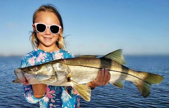 Camille Caravello caught herself this sweet snook from the beach. #takeakidfishing #girlsfishtoo