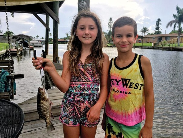 Best friends Logan and Kylah can't get enough of fishing, and worked together to  pull this little snapper.