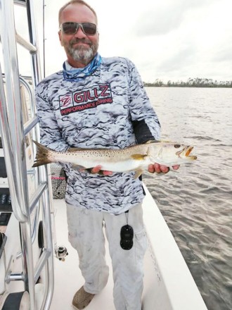 Capt C-note with one of the many big trout our bay system has been kicking out