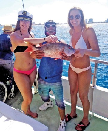 Justin and some fisher gals with a nice mutton snapper