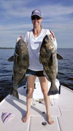 Michelle Wyatt holds two of the 21 black drum she caught and released during a fun day on the Indian River.