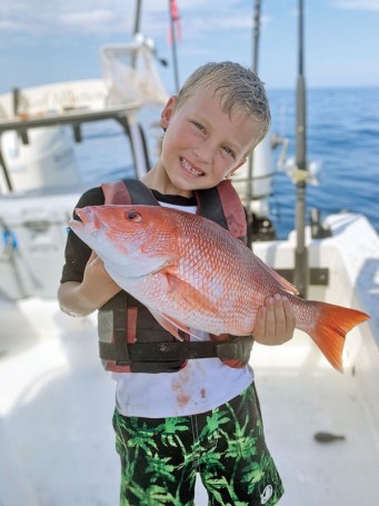 Brantley, 6, shows off the red snapper he took out of Sebastian.
