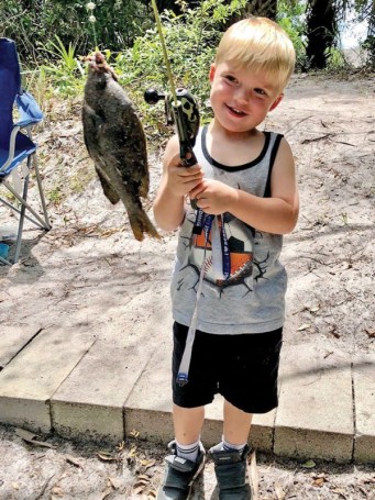 Four-year-old Sawyer Bass caught his first 10-inch sunfish using worms in a canal in Canaveral Groves.
