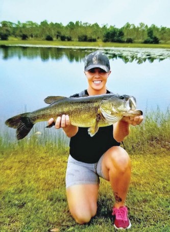 Heather Matson, holding her personal best bass she caught in a Brevard pond.