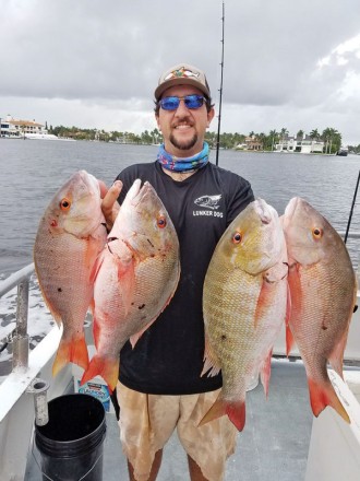 Loyal reader Chris Pascual with four keeper mutton snapper caught on one trip aboard the Catch My Drift.