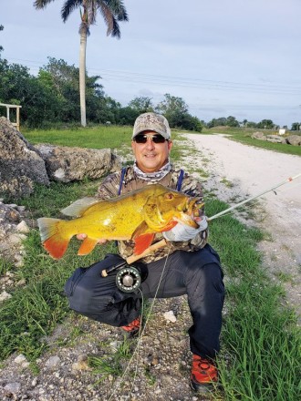 Tim Milan with a stud peacock bass caught on a fly