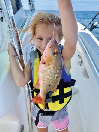 Five-year-old Brooke Mechler caught and released a mutton snapper while fishing with her dad