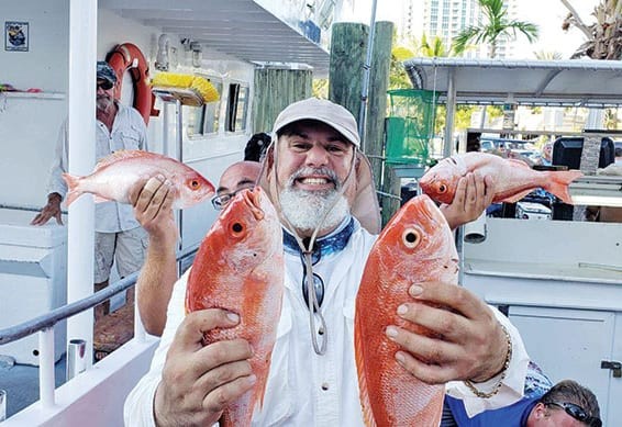 Andy with some nice snappers caught deep sea fishing.