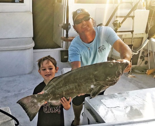 Capt. Rod and Jayden with a nice black grouper