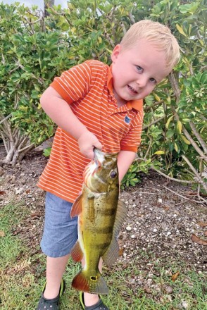 Four year old Bryce Sporrer with his first peacock bass.