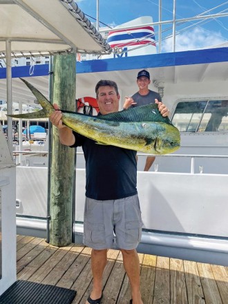 Happy Fishing Headquarters customer with a beautiful mahi mahi.