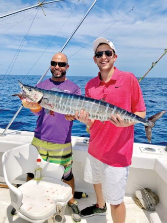Fishing Headquarters' Bobby and a happy angler holding a nice wahoo.