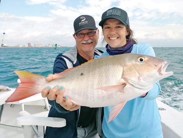 Happy anglers with a mutton snapper
