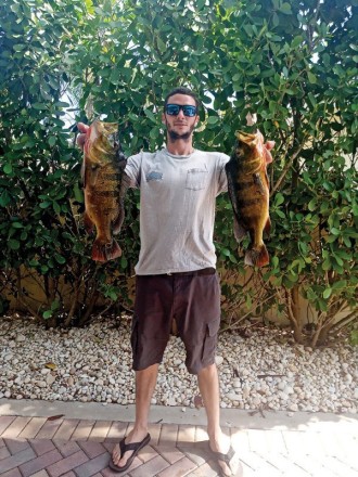 Steve Mistretta with a pair of nice peacocks caught in Parkland.