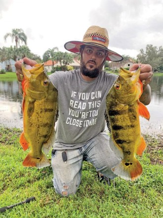 Tym Walker aka @kaya_mystic_daddy with a pair of quality peacock bass.