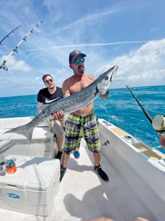 Mick with a big barracuda caught with New Lattitude Sportfishing.