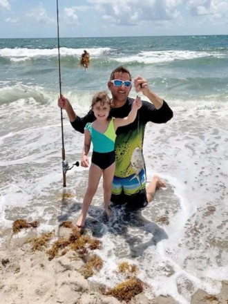 Five year old Stella and her proud dad Rob with her first catch ever, a palometa