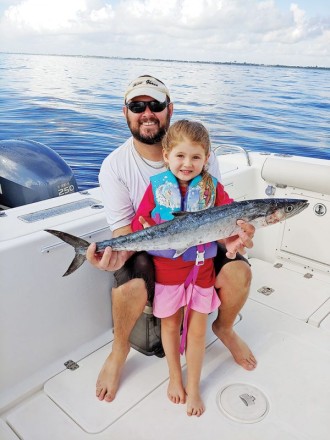 Four year old Caylee Dyer caught her first kingfish with a little help from her dad