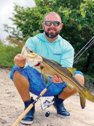 Capt. Mark DiDario with a snook caught on the freshwater side of a local spillway.