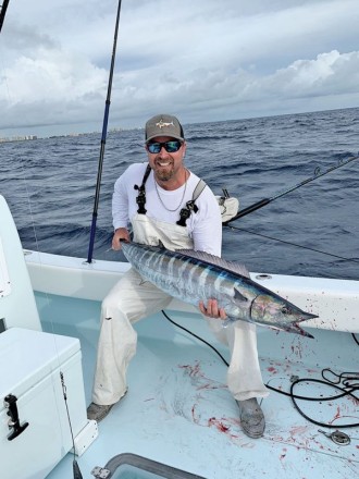 Capt. Ryan Palmer with a solid wahoo caught high speed trolling in 200 feet of Fort Lauderdale.