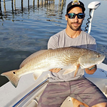 Ryan Caravello with the redrish  he caught off a Brevard dock.  Said it put up quite the battle!