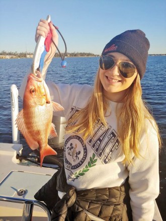 A lovely Ms. Dallas catching bay snapper on a chilly day with dad.