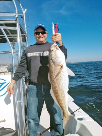 Aaron bagging bull reds on the C-note boat.