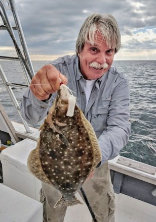 Capt. Chester with an offshore flounder