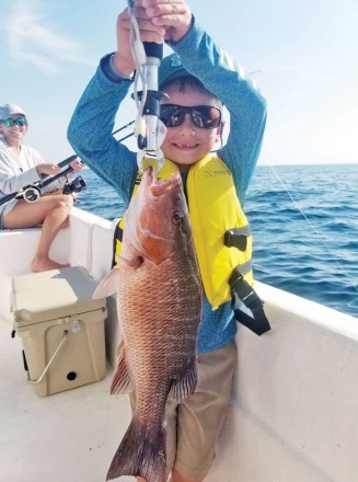 Gavin Gonterman from Corpus Christi, TX, cranking up mangrove snapper with Capt. Jason.