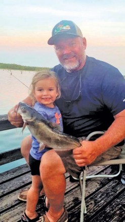Ken Morey and his grandbaby, Autrey, with a nice cat she hauled in on Lake Seminole