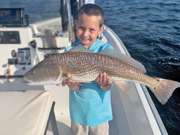 The kids are all smiles when fishing with Capt. Garrison and Reel Rosie Charters.