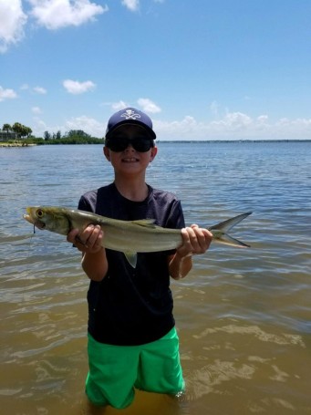 Sam String, age 8, catching his first lady fish in the Indian River off his kayak. Jumped in water for the photo opp.