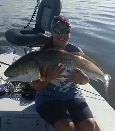 Wife, Denise Rolon Catching a Huge Redfish in Mosquito Lagoon