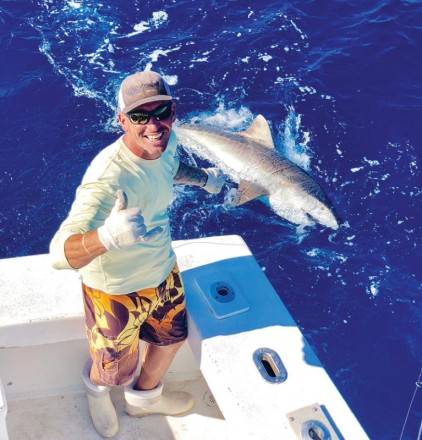 Mick with a nice tiger shark caught and released.