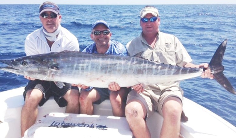 Jamie Jordan (left), Aaron Fahnestock (center), and John Shelton caught this beautiful wahoo on 50lb fluorocarbon.