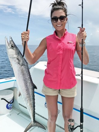 Lady angler with a solid kingfish caught with Nomad Fishing Charters.