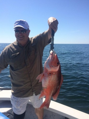 Chappy catching amazing red snapper while fishing with Underdog Charters.