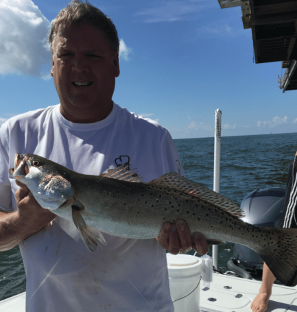 Capt. Charlie Grey of Grey Gulf Charters shows off a nice Speckled Trout fishing off of Dauphin Island.