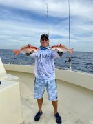 Matt Kane with twin vermilion snappers caught with a bottom dropping rig and squid bait at 290 feet out of Boynton Beach Inlet.