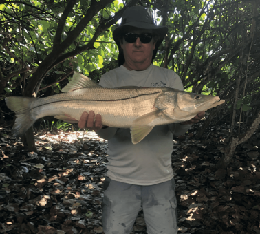 Wally Cheslock with and over-slot size snook at tail- end of mullet run in Melbourne Beach