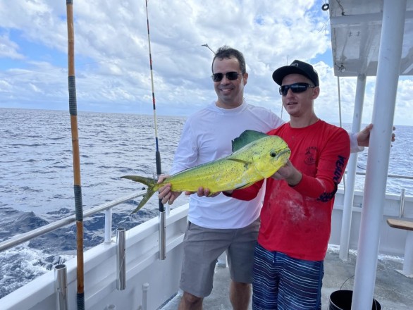 Two anglers sharing a mahi mahi pic while out with Fishing Headquarters.