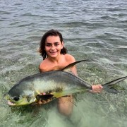 Mason Beller and a big permit caught in the surf in Key West.