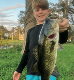 Gunner Wolf with a nice bass he caught on a Zoom Fluke, Lake Charm in Oviedo