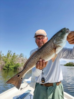 Capt. Tom Marks with a 28 inch redfish caught near Placida Fl.