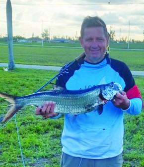 Denis Burke with a canal tarpon caught on a fly rod.