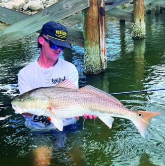 @Sea_Shur_jewelry shared:  @adam_ross_boss with a nice redfish while sporting the tarpon pendant.