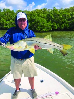John Yetter w/ a beautiful 37.5” snook caught at the opening of Alderman Creek.