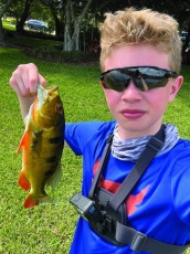 Colton Sunday showing off his latest catch, 2 lbs and 15 inches.