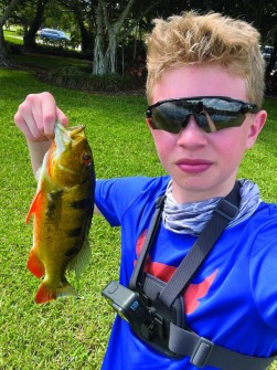 Colton Sunday showing off his latest catch, 2 lbs and 15 inches.