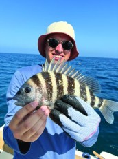 First time fisherman Micah McDaniel was happy w/ his sheepshead while fishing in the Gulf, out of Naples.